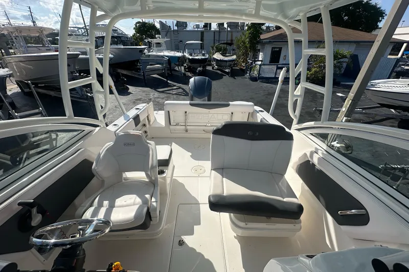 Slide: The Image of 2018 Robalo R247 Dual Console boat interior with seating and steering wheel. - 13