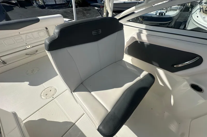Slide: The Image of 2018 Robalo R247 Dual Console boat interior with cushioned seating and sleek design. - 16