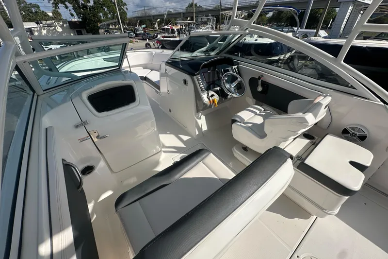 Slide: The Image of 2018 Robalo R247 Dual Console boat interior with seating and helm station. - 18