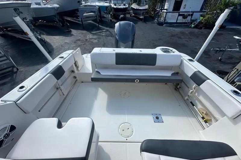 Slide: The Image of 2018 Robalo R247 Dual Console boat interior with seating and storage compartments. - 20