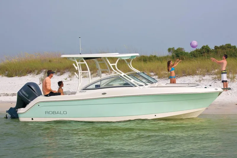 Slide: The Image of Manufacturer Provided Image: 2018 Robalo R247 Dual Console boat near beach with people playing ball. - 23