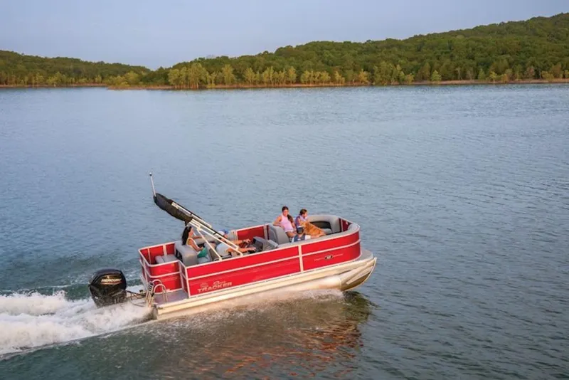 The Image of 2026 Sun Tracker Party Barge 18 DLX cruising on a serene lake. - 1
