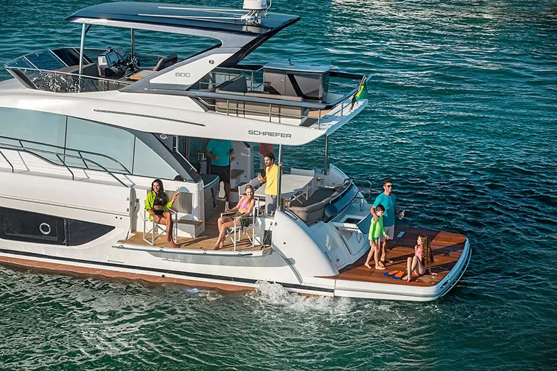 Slide: The Image of Luxury Schaefer 600 yacht from 2027 with people on deck. - 6