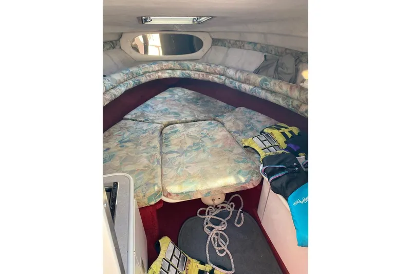 Slide: The Image of 1995 Chaparral 2335 SS boat cabin interior with floral upholstery and nautical gear. - 10