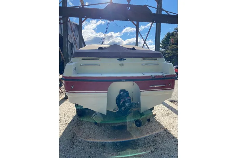 Slide: The Image of Rear view of a 1995 Chaparral 2335 SS boat under a sunny sky. - 13