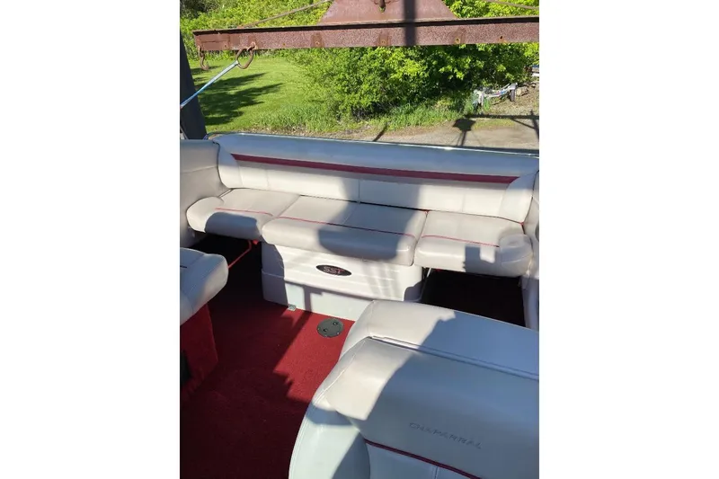 Slide: The Image of Interior of a 1995 Chaparral 2335 SS boat with white seating and red accents. - 4