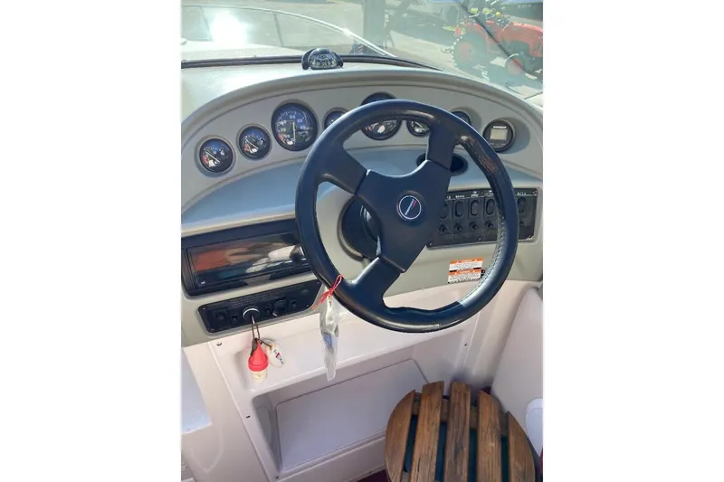 Slide: The Image of 1995 Chaparral 2335 SS boat dashboard with steering wheel and instrument panel. - 7