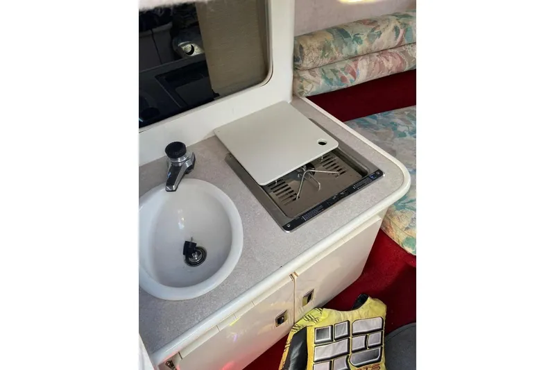 Slide: The Image of Interior of 1995 Chaparral 2335 SS boat with sink and stove in cabin. - 8