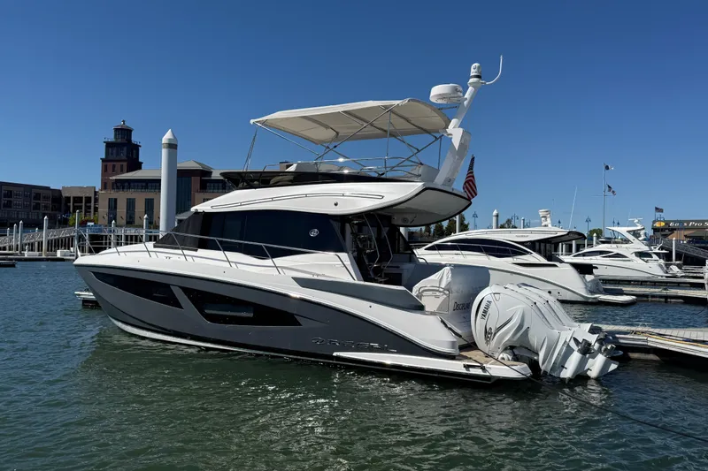 The Image of 2022 Regal 42 FXO yacht docked at marina under clear blue sky. - 0