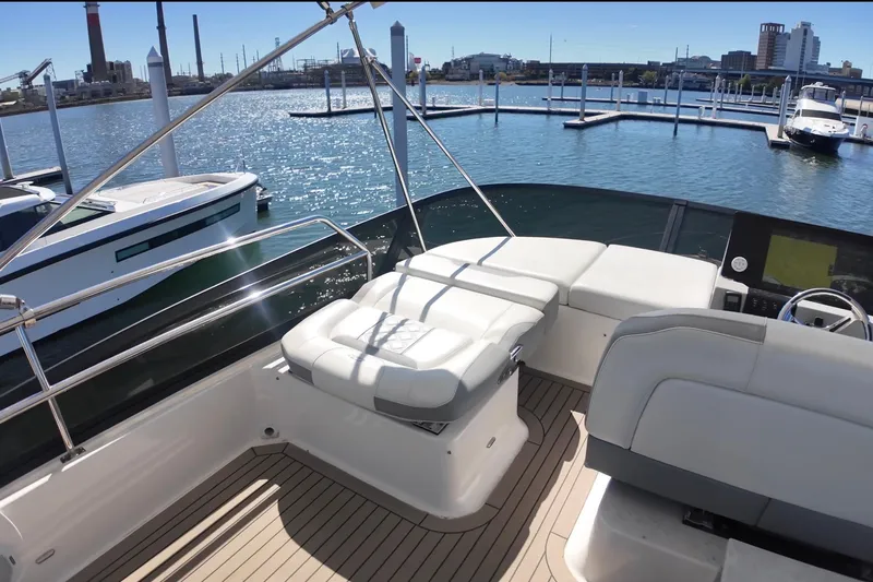 Slide: The Image of 2022 Regal 42 FXO yacht interior with luxurious seating and waterfront view. - 10