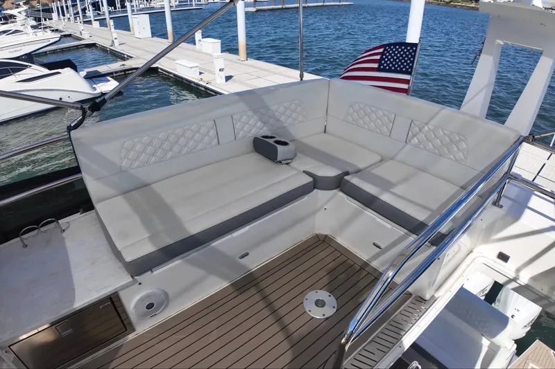 Slide: The Image of Luxurious seating area on a 2022 Regal 42 FXO yacht at a marina. - 12
