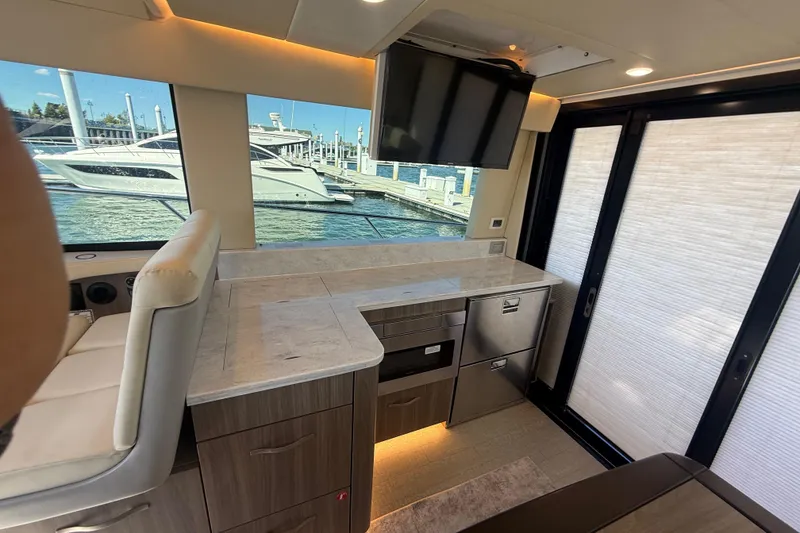 Slide: The Image of Luxurious interior of 2022 Regal 42 FXO yacht with modern kitchen and marina view. - 21