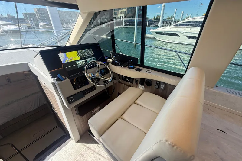 Slide: The Image of Luxurious 2022 Regal 42 FXO yacht cockpit with modern navigation system and plush seating. - 25