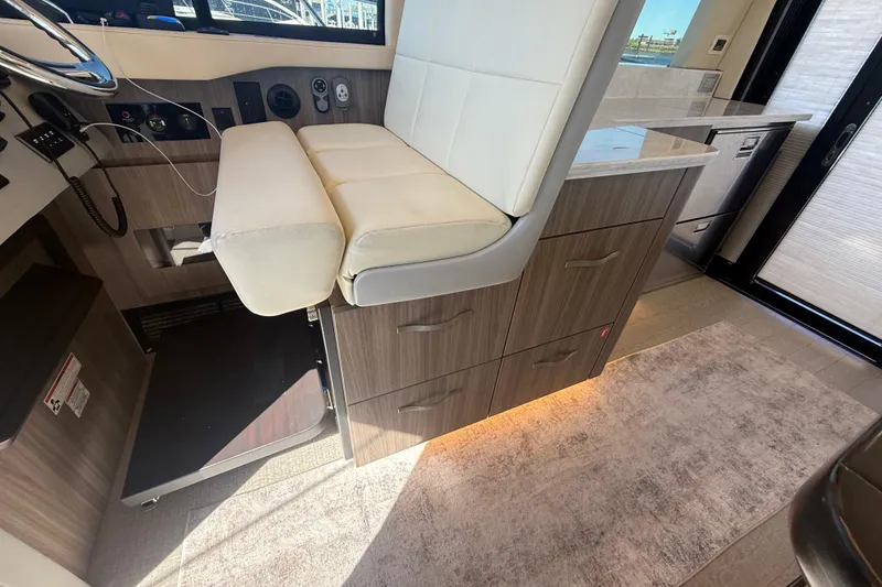 Slide: The Image of Interior of 2022 Regal 42 FXO yacht with modern seating and cabinetry. - 27