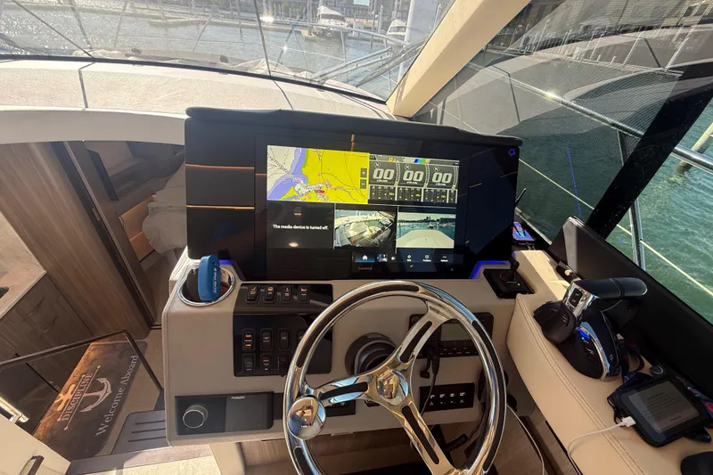 Slide: The Image of Cockpit of 2022 Regal 42 FXO yacht with advanced navigation system and steering wheel. - 28