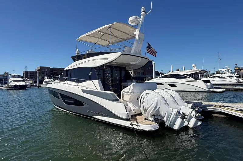 Slide: The Image of 2022 Regal 42 FXO yacht docked at marina under clear blue sky. - 3