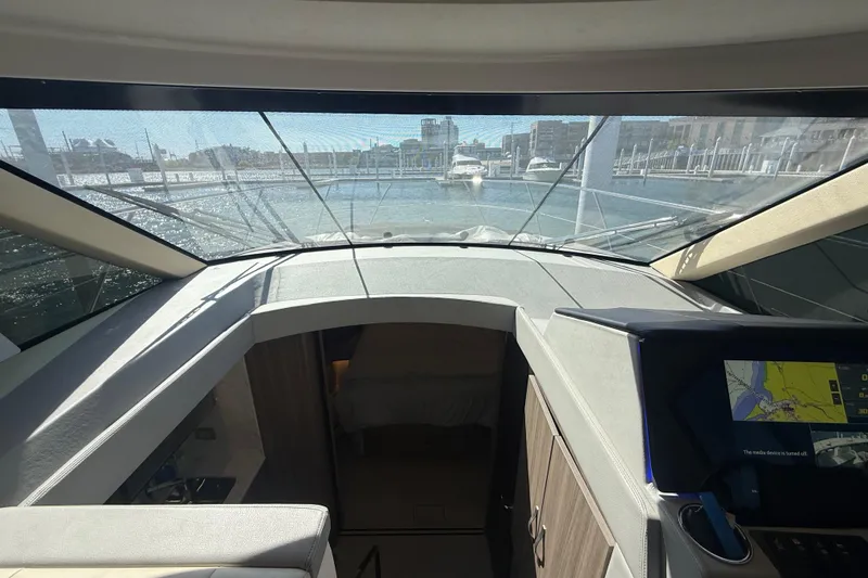 Slide: The Image of Interior view of 2022 Regal 42 FXO yacht cockpit with navigation display. - 31
