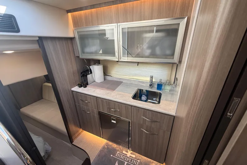 Slide: The Image of Luxurious 2022 Regal 42 FXO yacht interior with modern kitchenette and sleek cabinetry. - 34