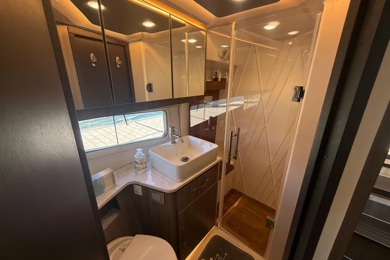 Slide: The Image of Luxurious bathroom interior of 2022 Regal 42 FXO yacht with modern fixtures and glass shower. - 37
