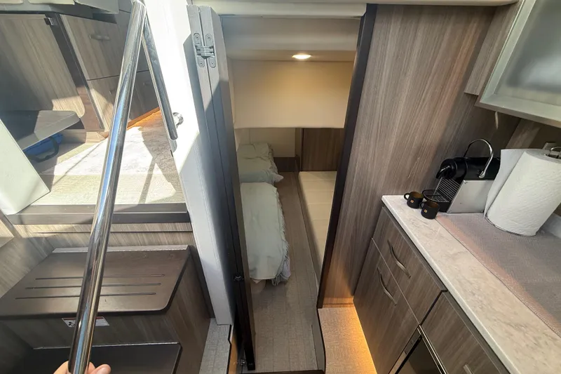 Slide: The Image of Luxurious interior of 2022 Regal 42 FXO yacht with modern kitchen and cozy sleeping area. - 40