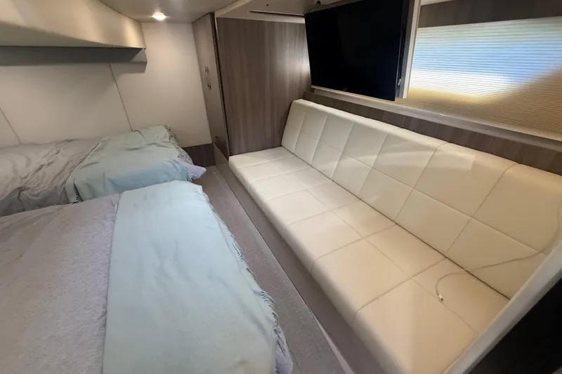 Slide: The Image of Interior of 2022 Regal 42 FXO yacht with beds, sofa, and TV. - 43