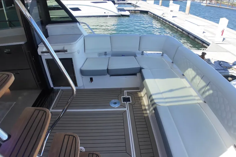 Slide: The Image of Luxurious seating area on 2022 Regal 42 FXO yacht, docked at marina. - 5