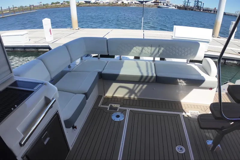 Slide: The Image of Luxurious seating area on a 2022 Regal 42 FXO yacht, docked by the water. - 6