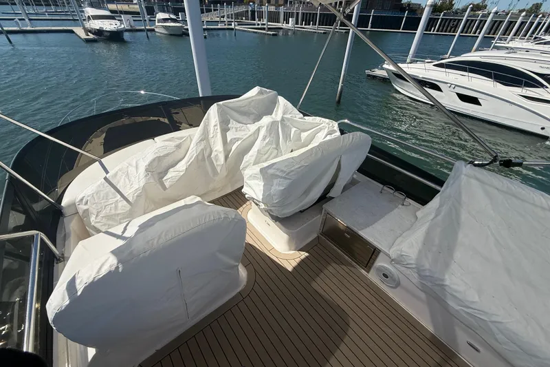 Slide: The Image of Covered seating area on 2022 Regal 42 FXO yacht docked at marina. - 9
