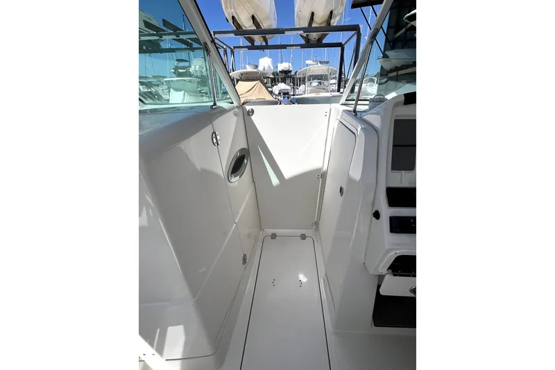 Slide: The Image of 2024 Sailfish 245 DC boat interior, showcasing sleek white design and modern features. - 26