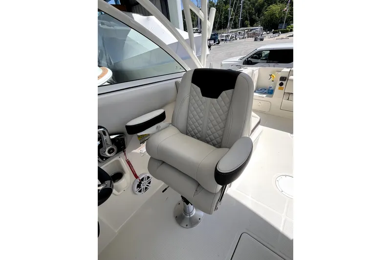 Slide: The Image of 2024 Sailfish 245 DC boat captain's chair with quilted upholstery and armrests. - 14