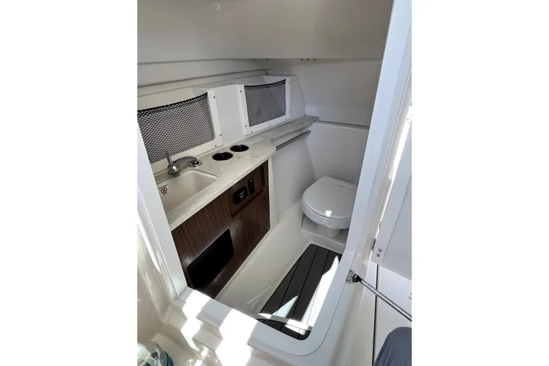 Slide: The Image of 2024 Sailfish 245 DC boat interior with sink and toilet. - 19