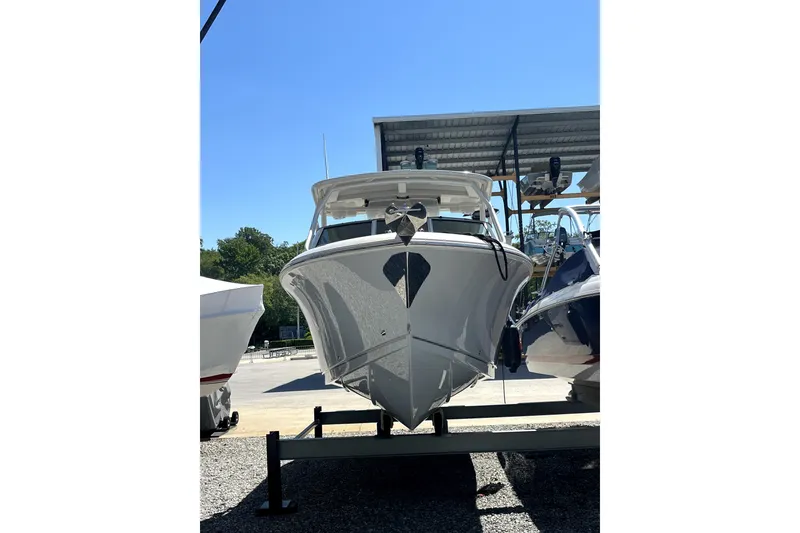Slide: The Image of 2024 Sailfish 245 DC boat on trailer under clear blue sky. - 3