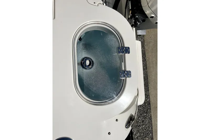 Slide: The Image of Livewell on 2024 Sailfish 245 DC boat, featuring a clear lid and secure hinges. - 40