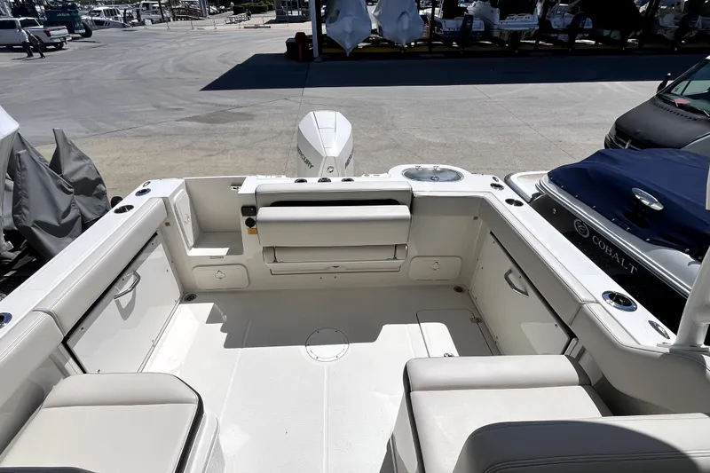 Slide: The Image of 2024 Sailfish 245 DC boat interior with seating and storage compartments. - 12