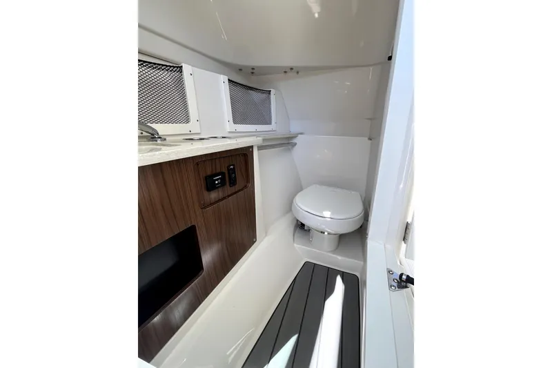 Slide: The Image of 2024 Sailfish 245 DC boat interior with compact bathroom and modern amenities. - 20