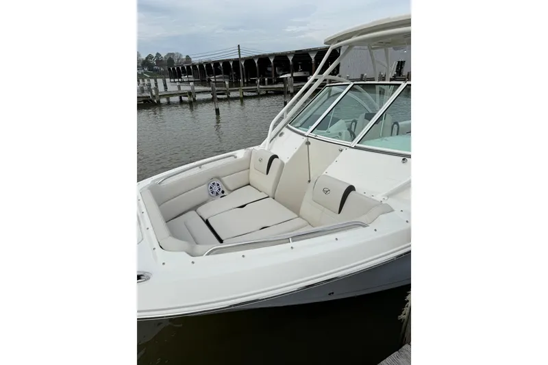 Slide: The Image of 2024 Sailfish 245 DC boat with spacious seating, docked by the water. - 47