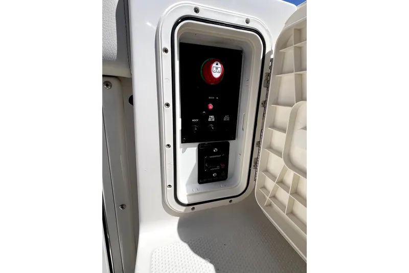 Slide: The Image of 2024 Sailfish 245 DC boat control panel with switches and indicators. - 34