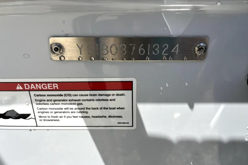 Slide: The Image of 2024 Sailfish 245 DC boat with serial number plate and carbon monoxide warning label. - 44