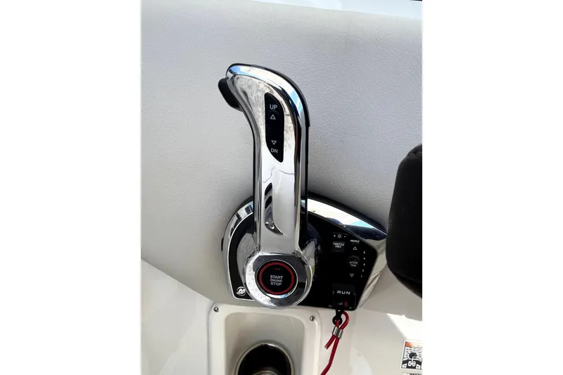 Slide: The Image of Throttle control of 2024 Sailfish 245 DC boat, featuring start/stop button and trim controls. - 33