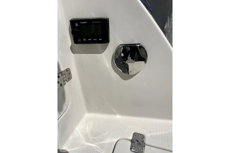 Slide: The Image of 2024 Sailfish 245 DC boat interior with Fusion MS-RA70N stereo system and chrome fixture. - 32