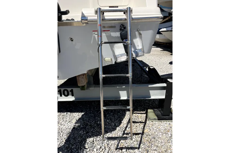 Slide: The Image of 2024 Sailfish 245 DC boat ladder on trailer, showcasing stainless steel design. - 30