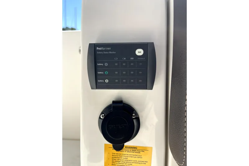 Slide: The Image of ProMariner battery status monitor on 2024 Sailfish 245 DC boat dashboard. - 21