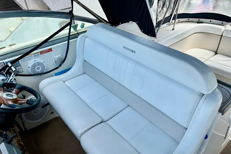 Slide: The Image of 2006 Rinker 390 Express Cruiser interior with white seating and steering wheel. - 14