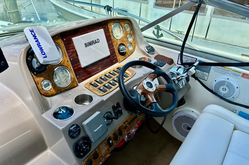 Slide: The Image of 2006 Rinker 390 Express Cruiser helm with navigation equipment and controls. - 15