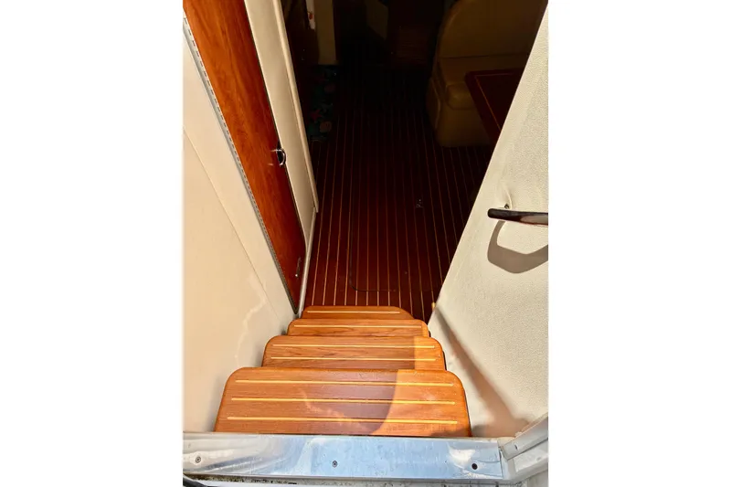 Slide: The Image of Wooden steps leading to cabin interior of 2006 Rinker 390 Express Cruiser. - 21