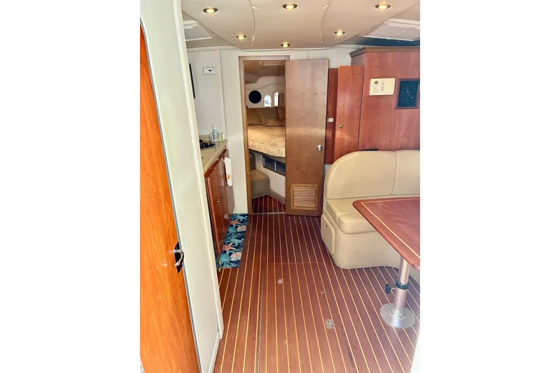 Slide: The Image of Interior of 2006 Rinker 390 Express Cruiser with wood flooring and cozy seating area. - 22