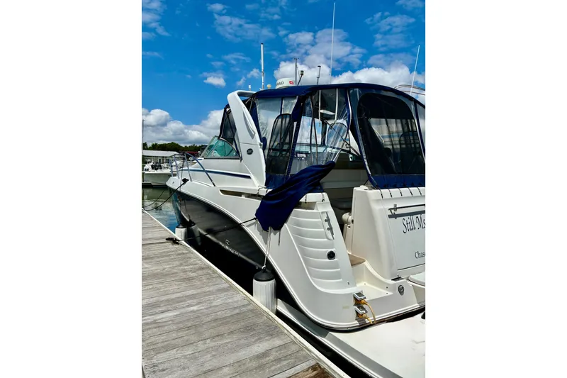 Slide: The Image of 2006 Rinker 390 Express Cruiser docked under a clear blue sky. - 3