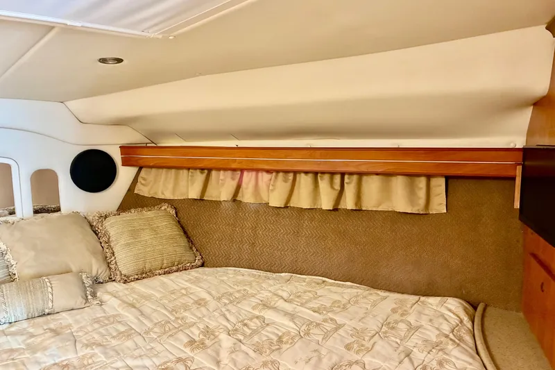 Slide: The Image of 2006 Rinker 390 Express Cruiser cabin interior with cozy bedding and elegant decor. - 37