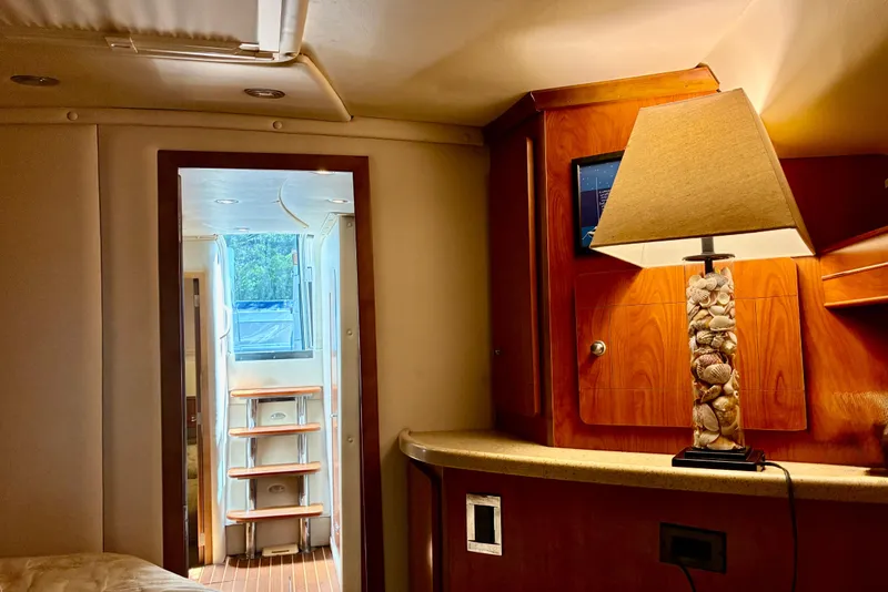 Slide: The Image of Interior of 2006 Rinker 390 Express Cruiser with elegant wood cabinetry and decorative lamp. - 39