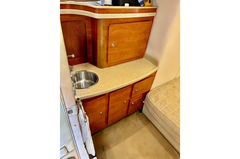 Slide: The Image of 2006 Rinker 390 Express Cruiser interior with wooden cabinetry and compact sink. - 40